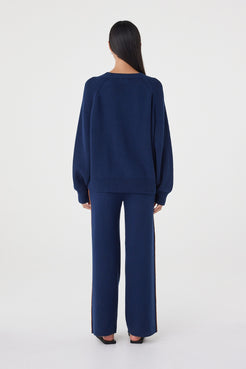 Back view of the Aubrey Sweater in Navy featuring a relaxed silhouette, ribbed hem detailing and soft knit construction.