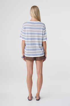 Noor Tee in White & Blue Retro Stripe, back view showing the relaxed silhouette and continuous stripe knit across the back.