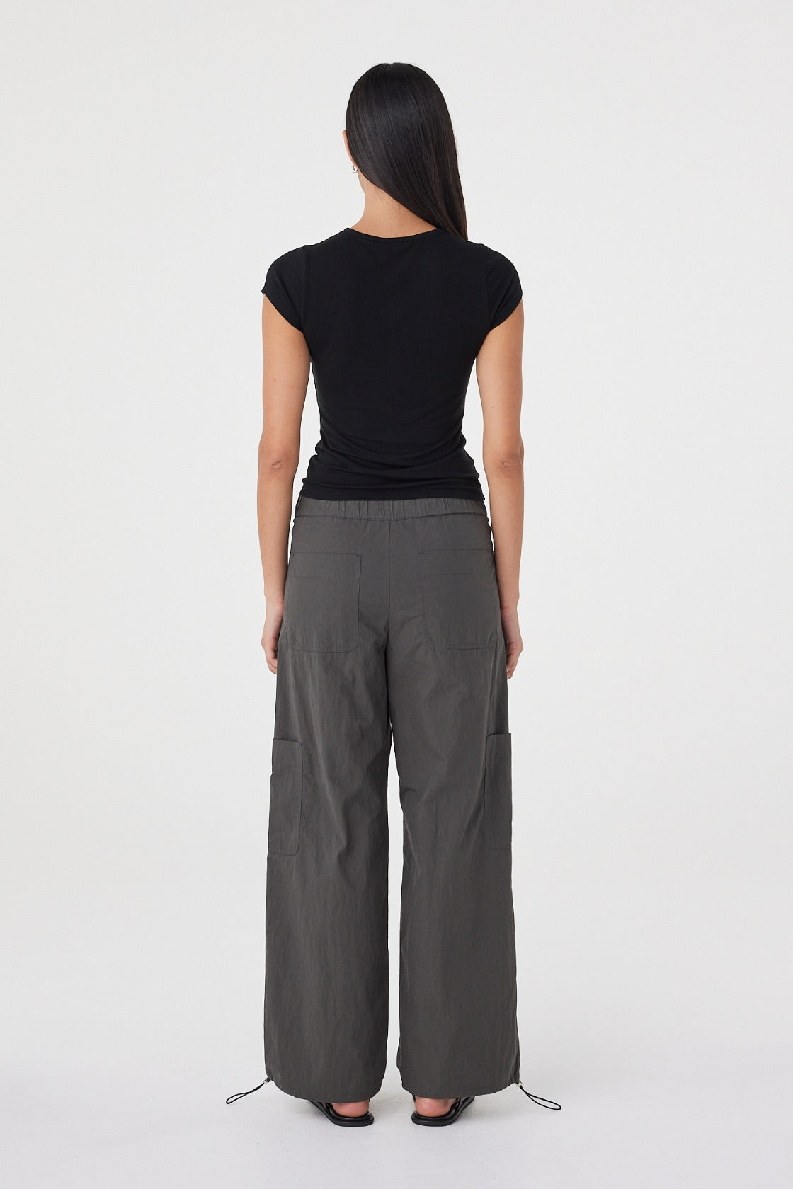 Back view of the Robbie Top in Black showcasing the clean fitted silhouette and smooth lightweight knit finish.