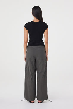 Back view of the Robbie Top in Black showcasing the clean fitted silhouette and smooth lightweight knit finish.