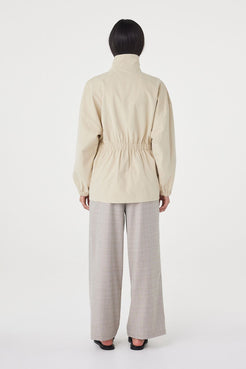 Back view of the Amari Jacket in Beige featuring a clean finish and relaxed fit through the body.