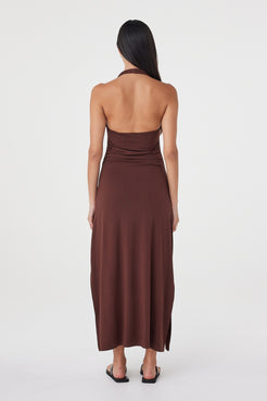 Back view of the Suki Dress in Espresso showing the open halter back, fitted waist and fluid maxi-length skirt.