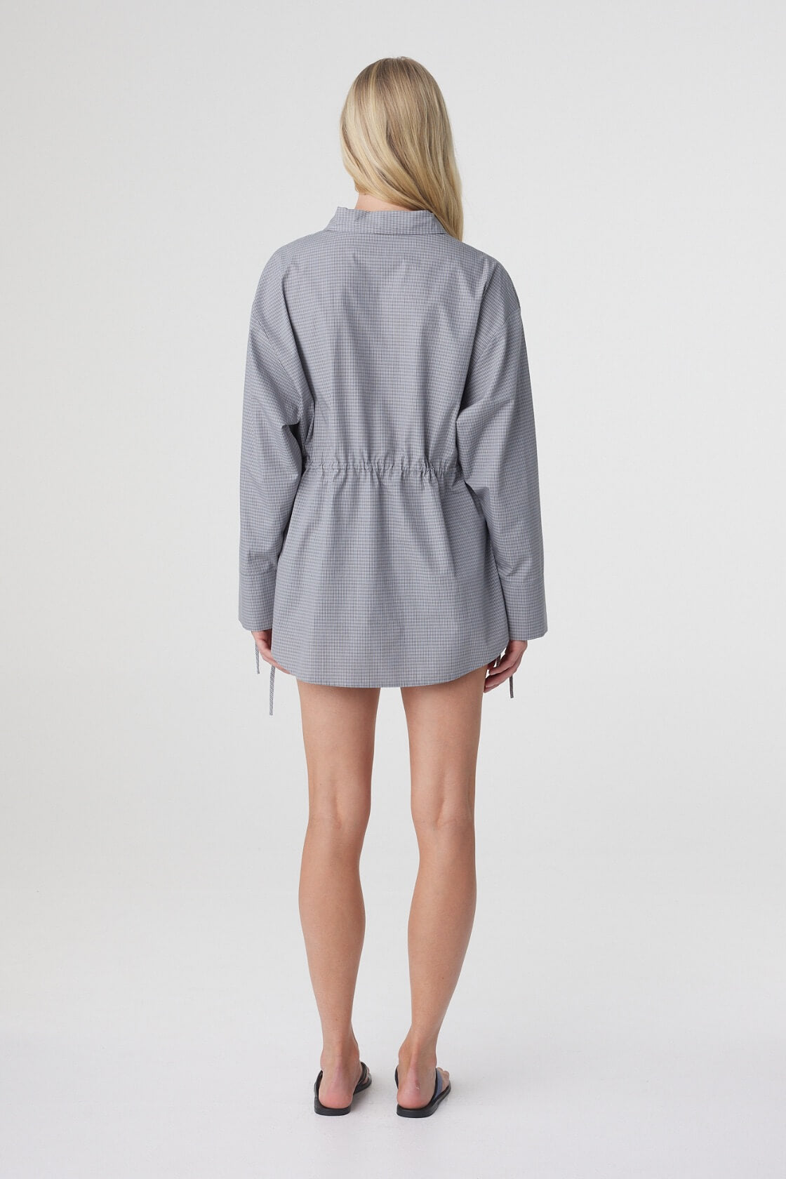 Back view of the Sia Shirt in Muted Blue Check, showing the oversized silhouette and long shirt length.