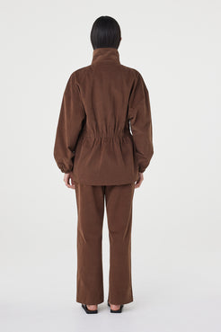 Back view of the Amari Jacket in espresso showing the elasticated waist detail, oversized fit and soft brushed cotton texture, worn with matching relaxed pants