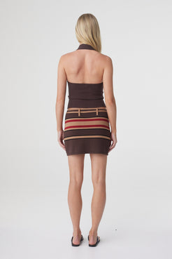 Thea Twist Top in Espresso with a striped mini skirt, back view showing the open halter back.