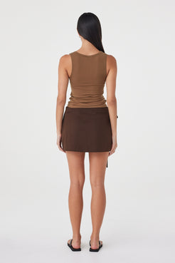 Back view of the Mable Tank in Deep Cedar showcasing the clean sleeveless design and streamlined silhouette. 