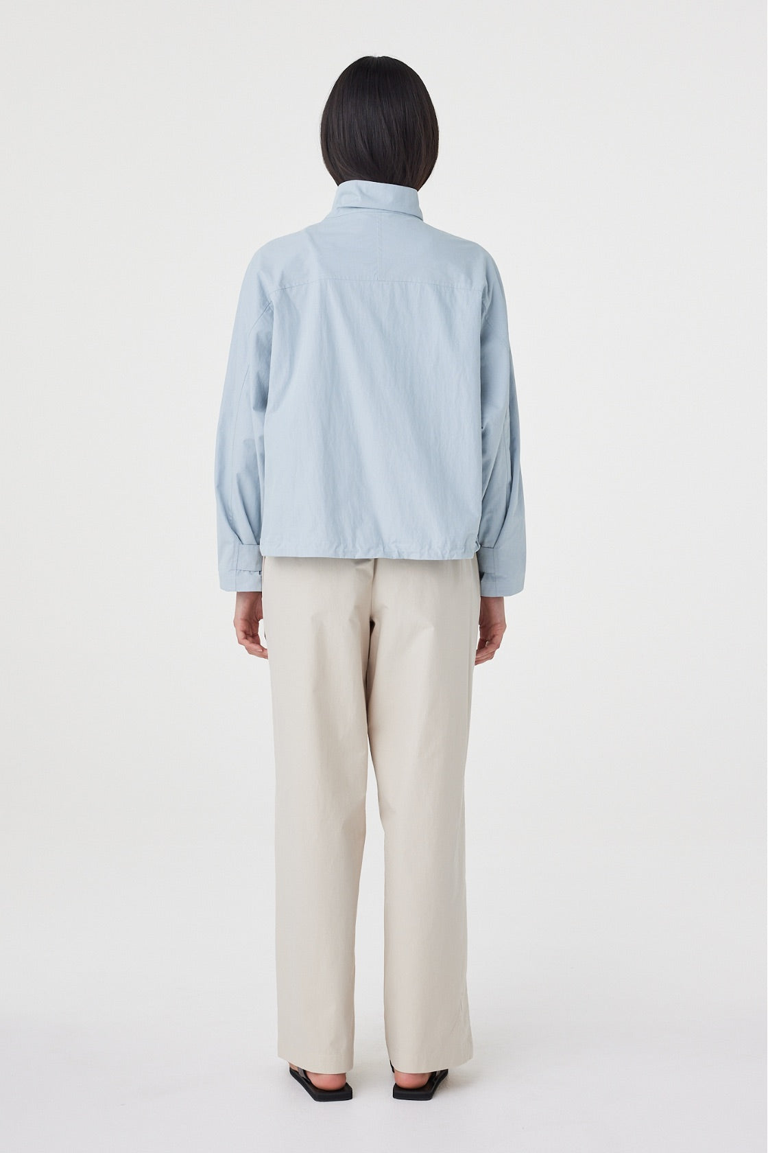 Back view of the Addie Jacket in Pale Blue highlighting the relaxed shape and lightweight cotton-nylon fabrication.