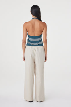 Back view of the Nuri Top in Teal Stripe showing the open-back halter silhouette and custom striped knit.