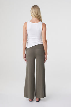 Elin Tank in Cream, back view styled with wide leg trousers, showing the fitted shape and clean sleeveless back.