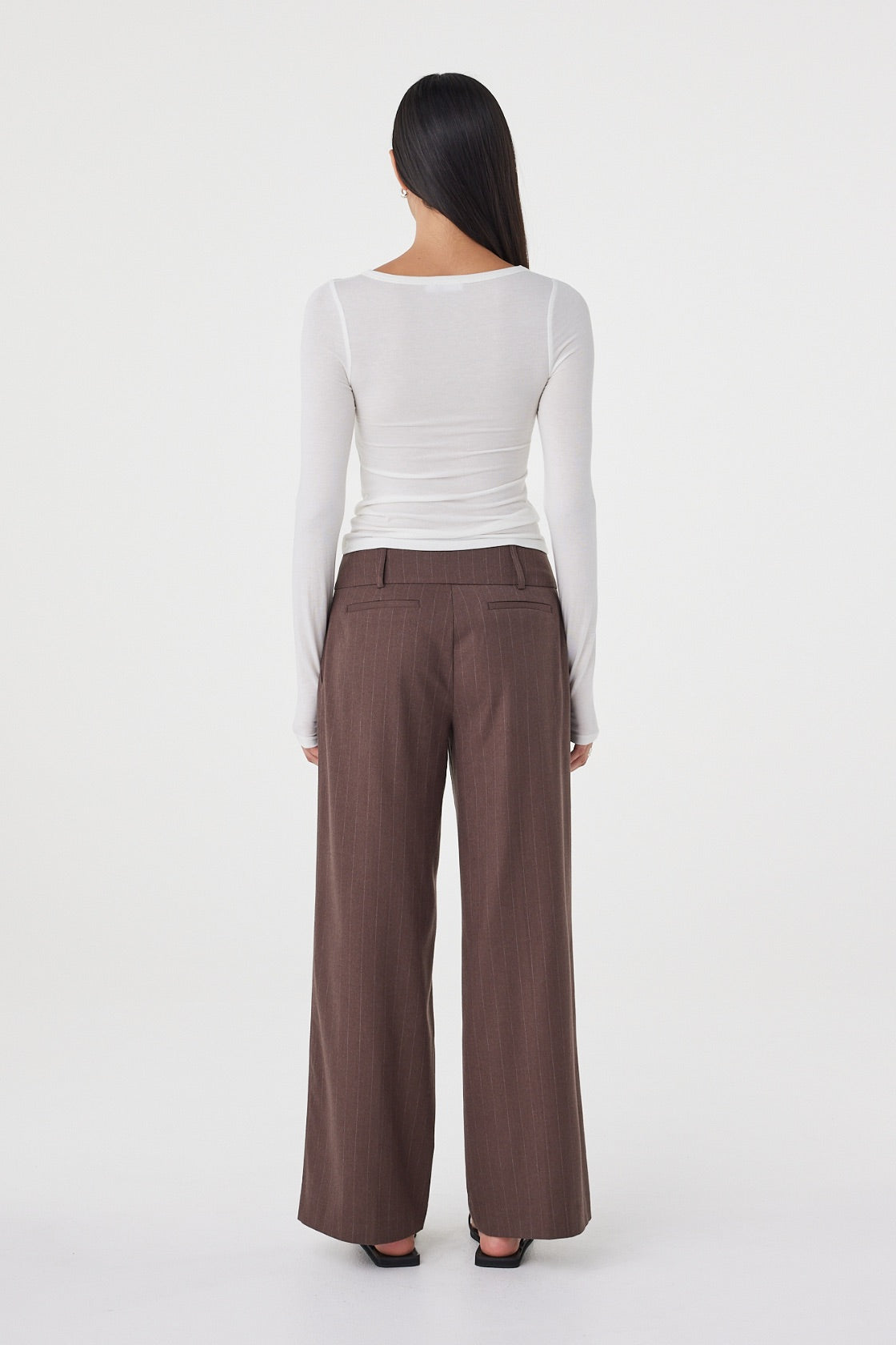 Back view of the Mabel LS Twist Top in Cream showcasing the smooth fitted silhouette and lightweight stretch knit construction.