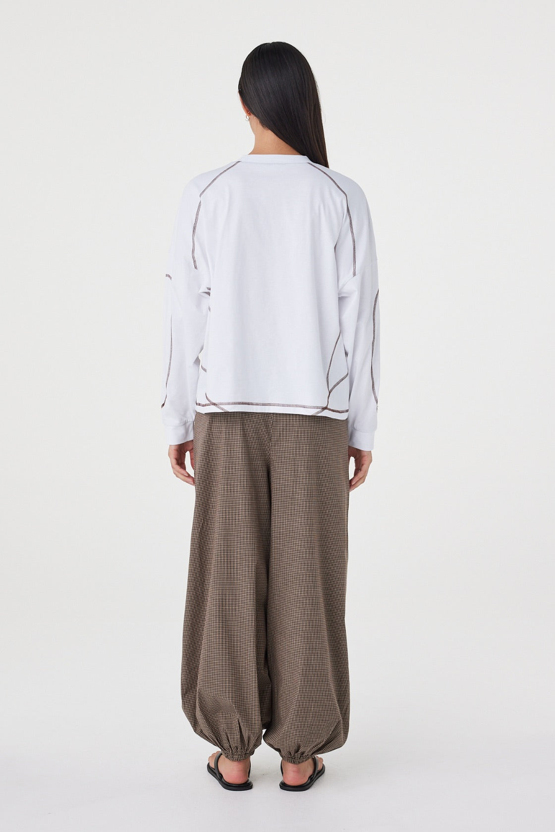 Back view of the Kesh LS Tee in Cream & Espresso showcasing the relaxed silhouette, dropped shoulders and contrast overlocking throughout.