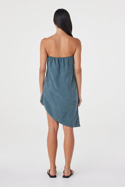 Back view of the Rhea Dress in Teal highlighting the strapless back, elasticated construction and fluid hemline.