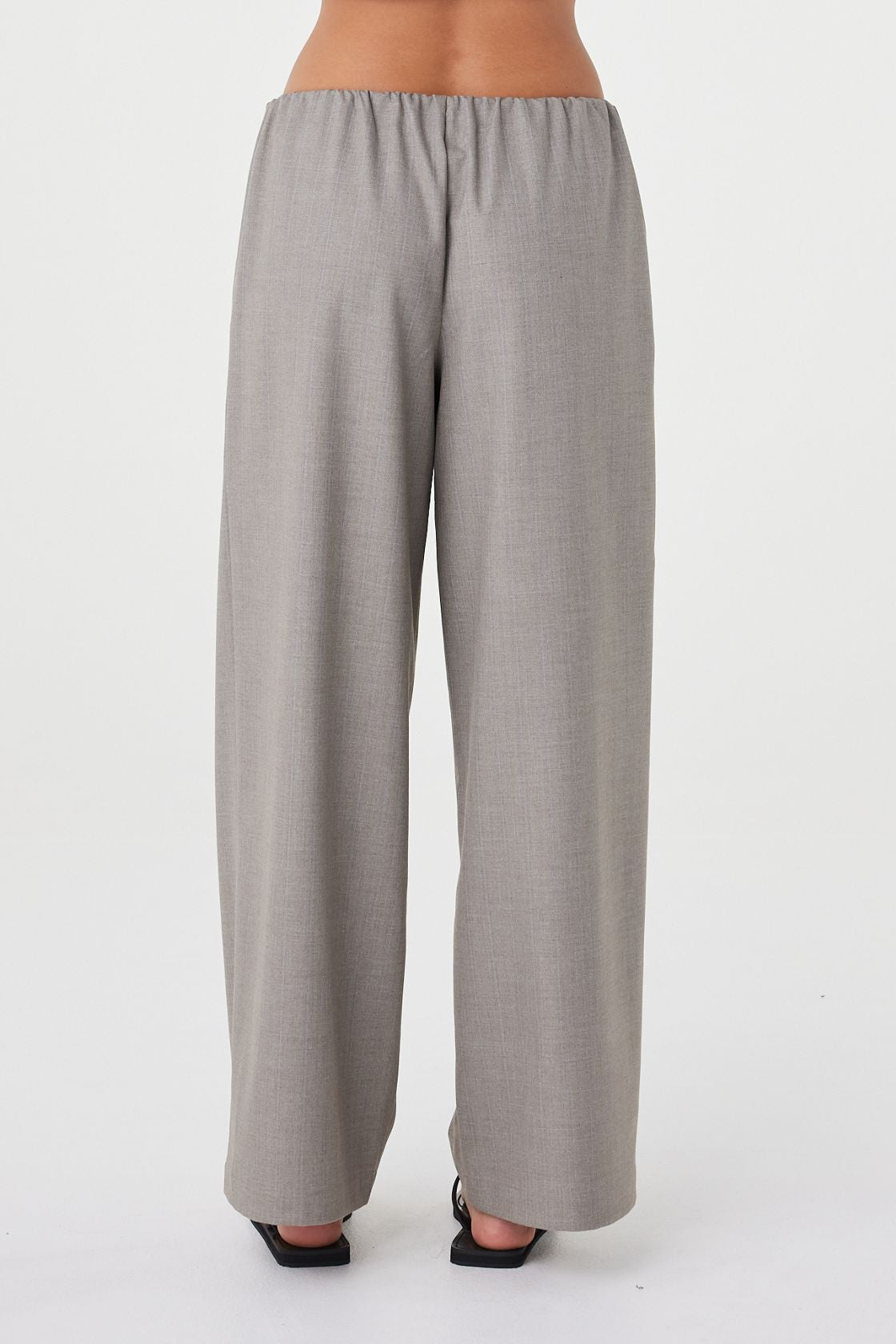 Back view of the Annika Pant in taupe blue pinstripe showcasing the relaxed silhouette, soft drape through the leg and clean slip-on waistband finish