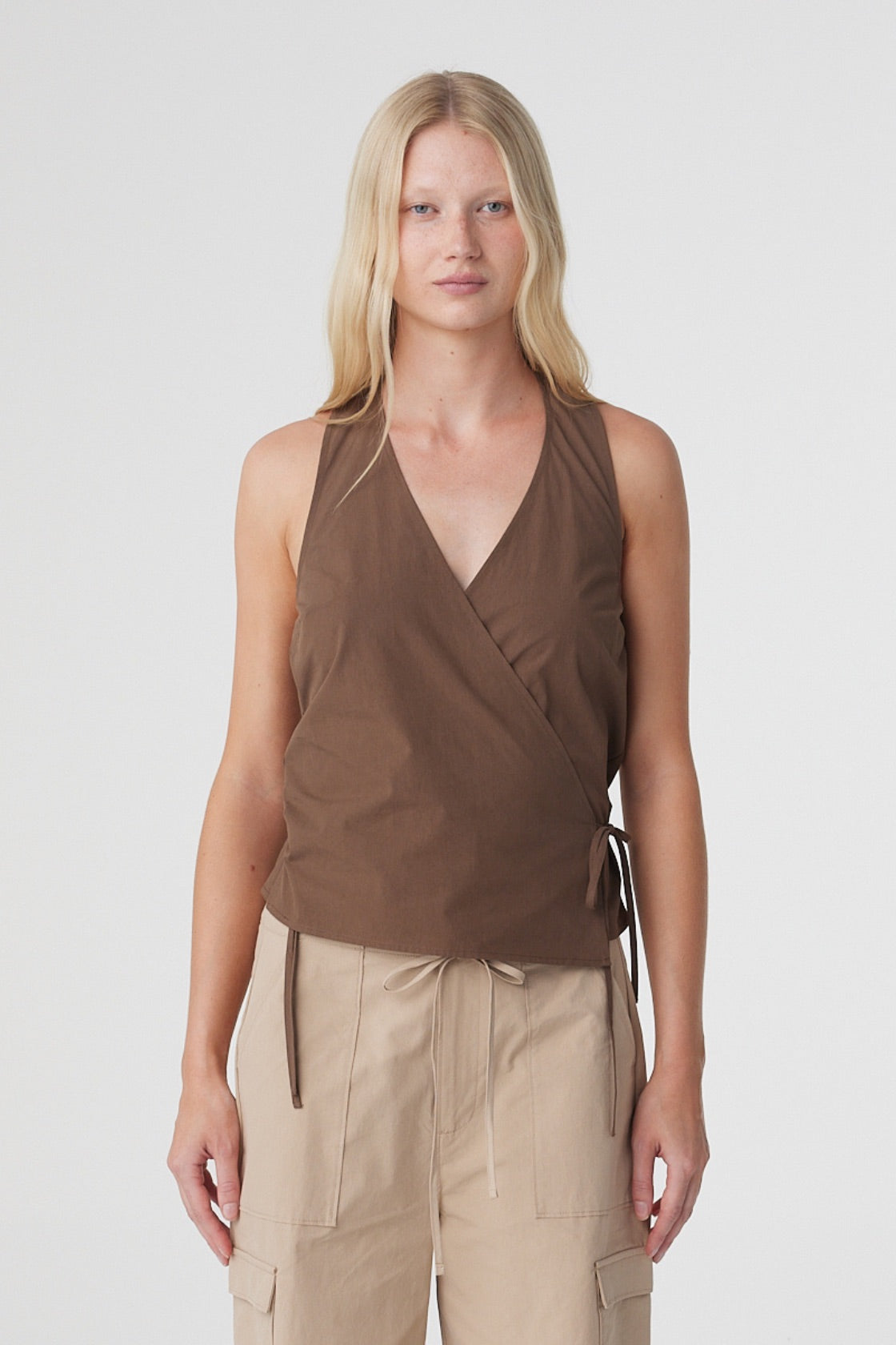 Lilia Wrap Top in Espresso, close front view showing the deep V halter neckline, overlapping wrap front and side tie.