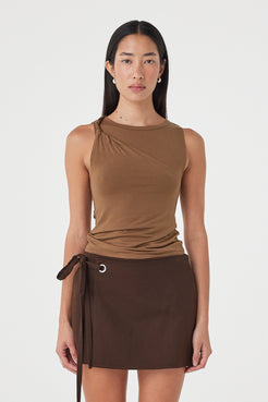 Front view of the Mable Tank in Deep Cedar featuring an asymmetric shoulder twist, subtle neckline gathering and slim silhouette, styled with the Lucia Tie Mini Skirt.