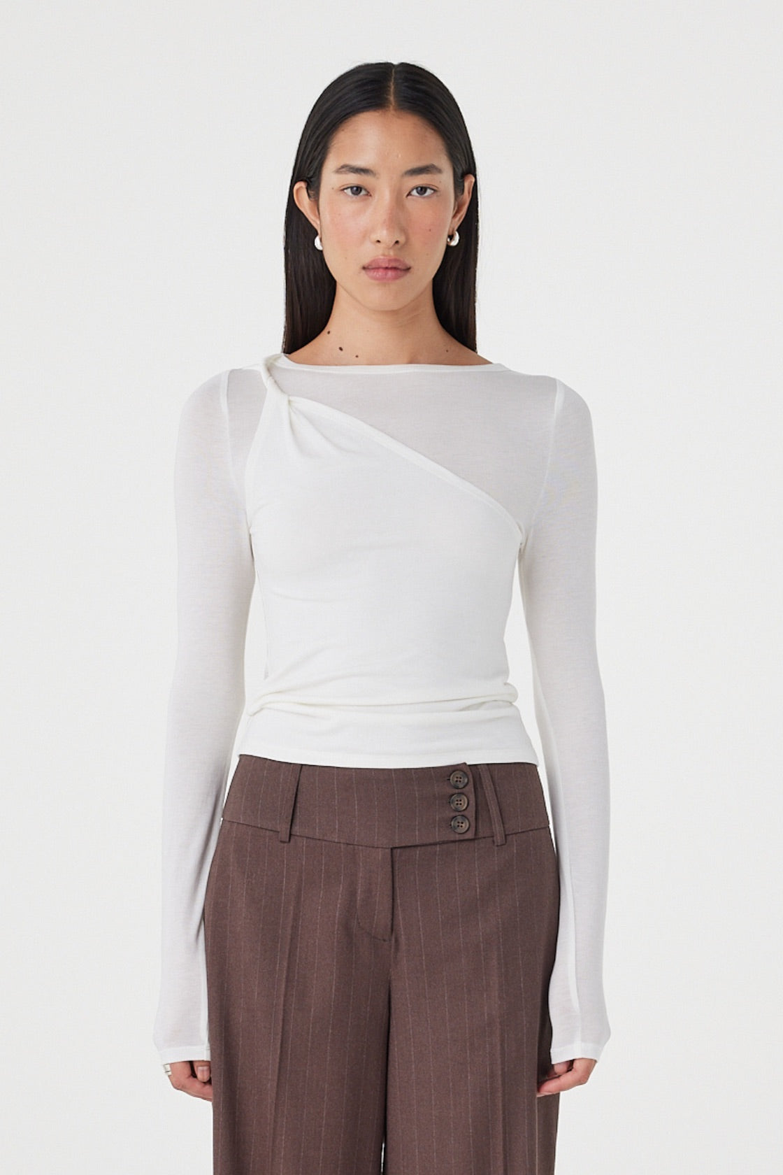 Front view of the Mabel LS Twist Top in Cream featuring an asymmetrical twist neckline, slim fitting silhouette and soft stretch knit, styled with the Manon Pant in Espresso Pinstripe.