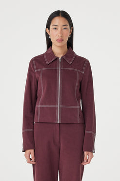 Front view of the Benny Jacket in Merlot featuring contrast stitching, lapel collar and silver zip-front closure, styled with matching merlot pants.