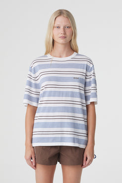Noor Tee in White & Blue Retro Stripe, front close view showing the custom striped knit, ribbed crew neckline and subtle Arcaa logo at the chest.