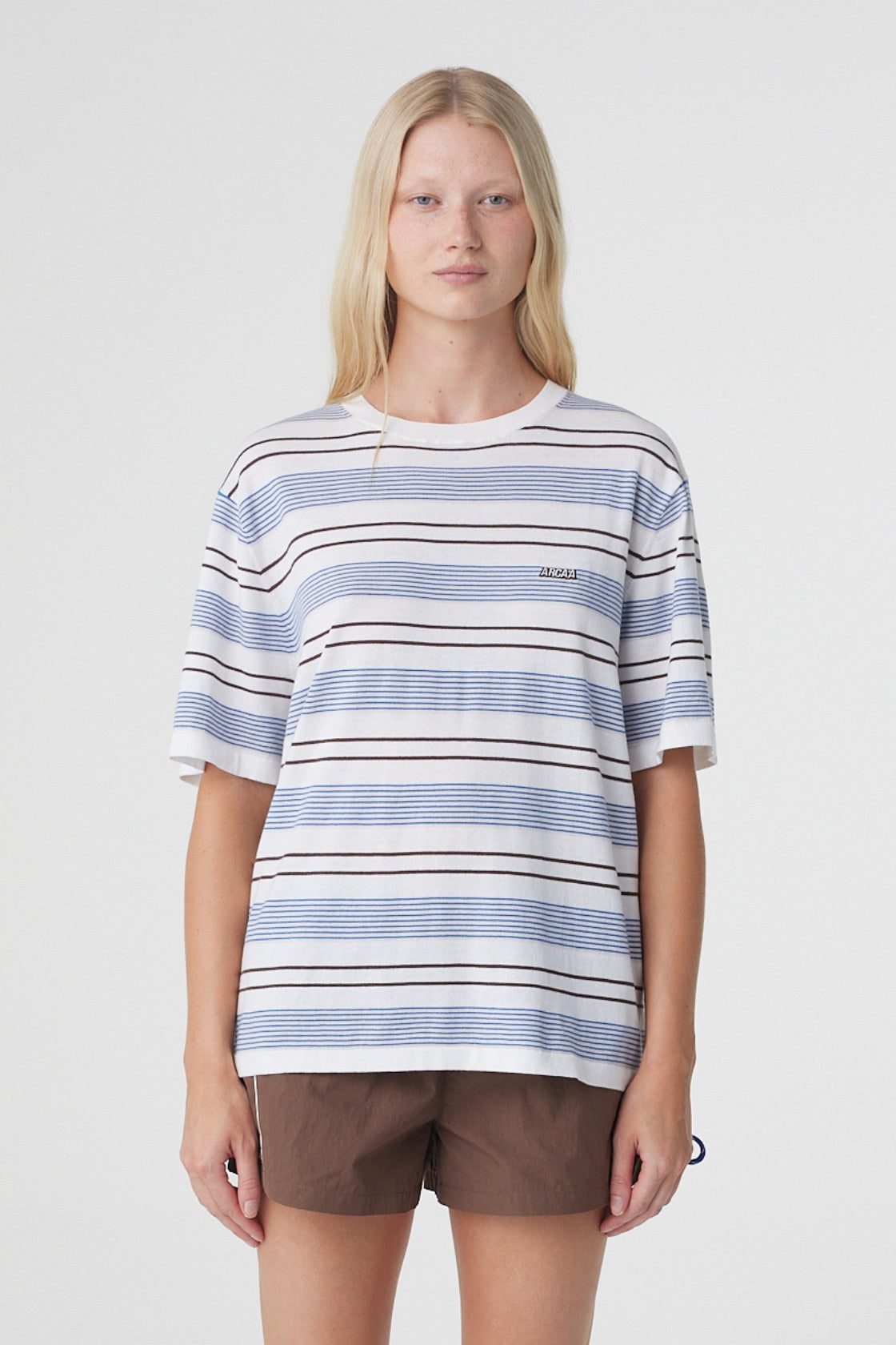 Noor Tee in White & Blue Retro Stripe, front close view showing the custom striped knit, ribbed crew neckline and subtle Arcaa logo at the chest.
