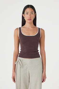 Front view of the Kaya Tank in Espresso & Cream featuring contrast trim, a slim-fitting silhouette and soft organic cotton knit, styled with light sage wrap pants.