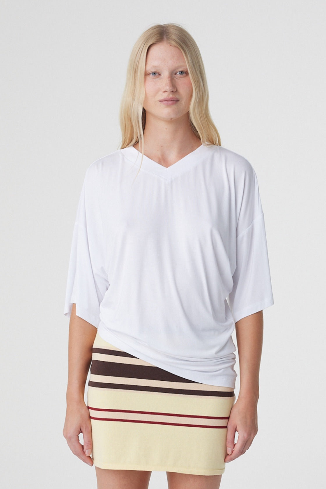 Blaine Tee in White, close front view showing the oversized fit, V neckline, dropped shoulders and asymmetrical hem.