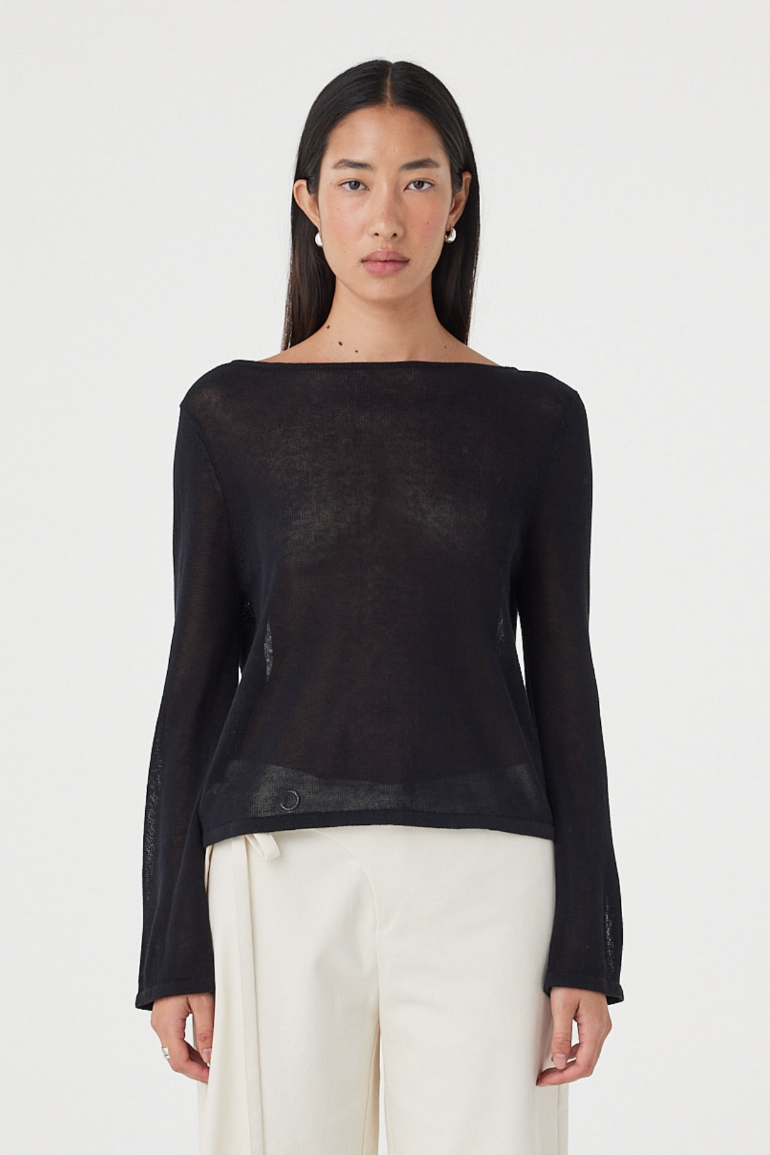 Front close-up view of the Nia LS Top in Black highlighting the sheer knit fabrication, boat neckline and loose silhouette.