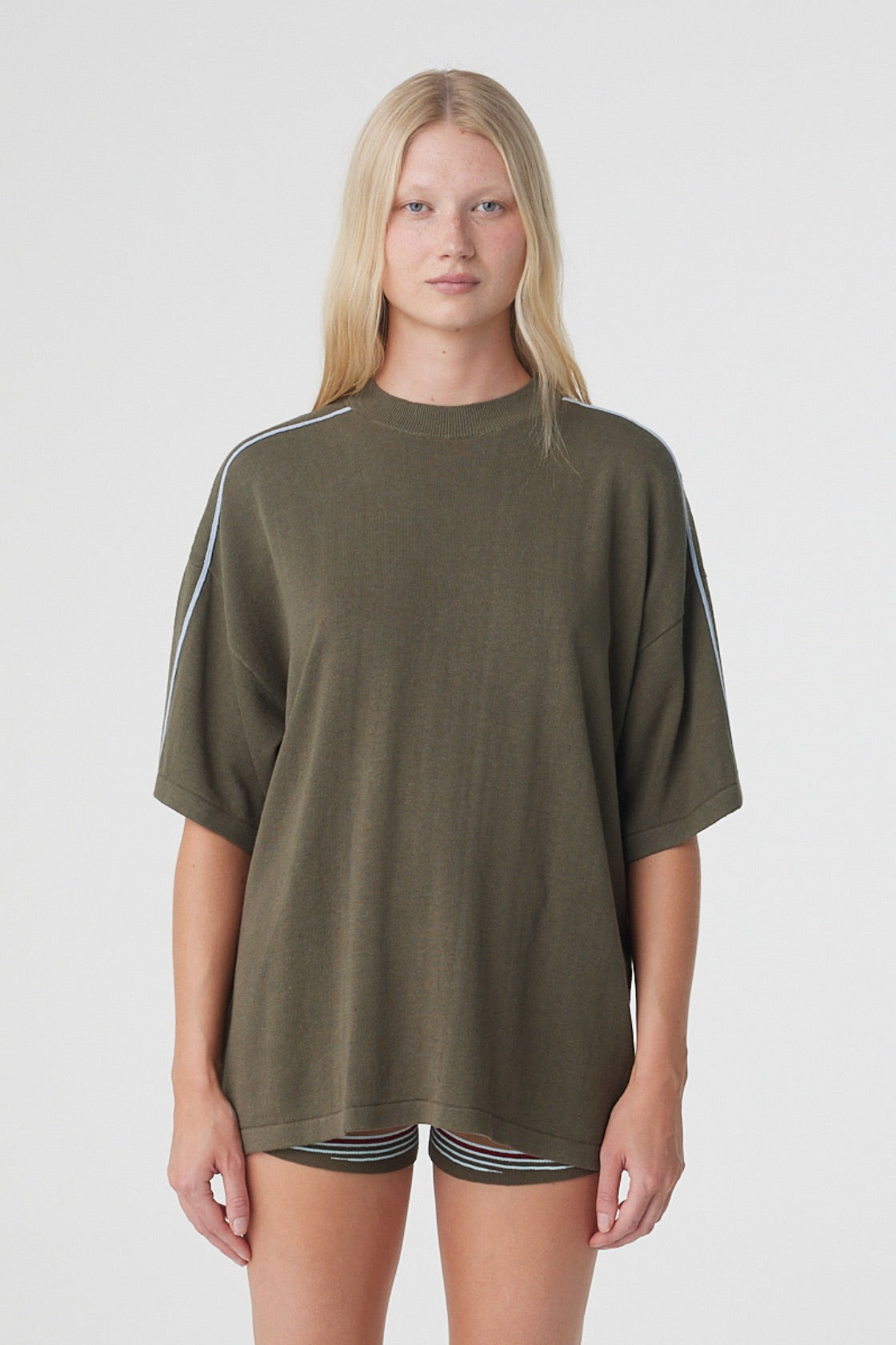 Pippa Oversized Tee in Smokey Olive and Dusk Blue, front close view showing the oversized fit, ribbed crew neckline and contrast piping over the shoulders.