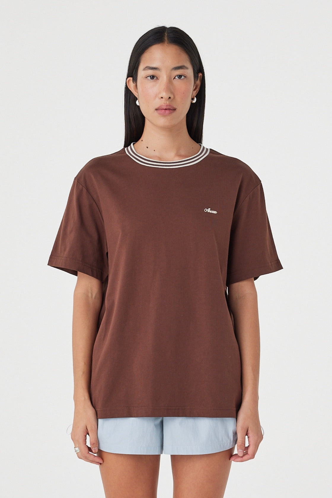Kylen Tee in Espresso & Cream close front view showing the oversized cotton silhouette, contrast striped crew neckline and embroidered Arcaa logo at the chest.