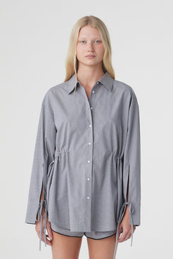 Sia Shirt in Muted Blue Check, close front view showing the oversized shape, button front and adjustable drawstrings at the waist.