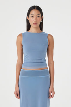 Front view of the Eden Reversible Top in Pale Blue & Espresso featuring the pale blue side, slim fit silhouette and curved neckline, styled with the matching skirt.