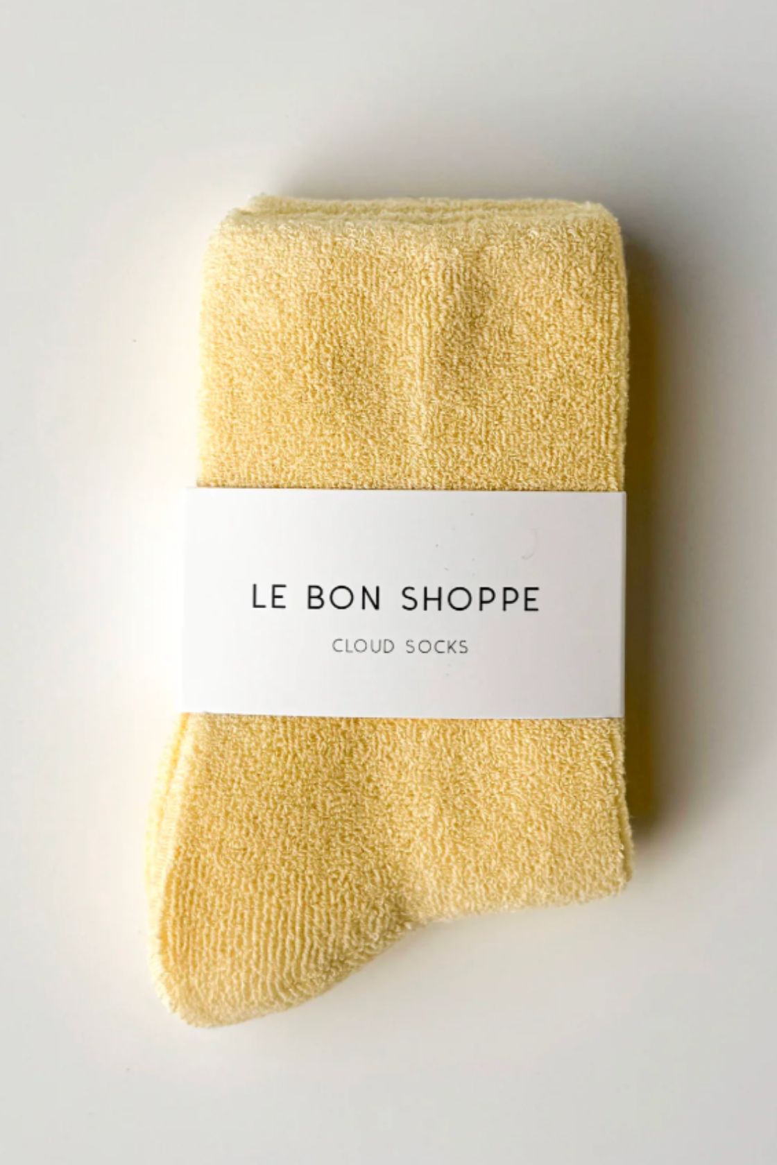 Lemon yellow terry cotton socks folded with Le Bon Shoppe label