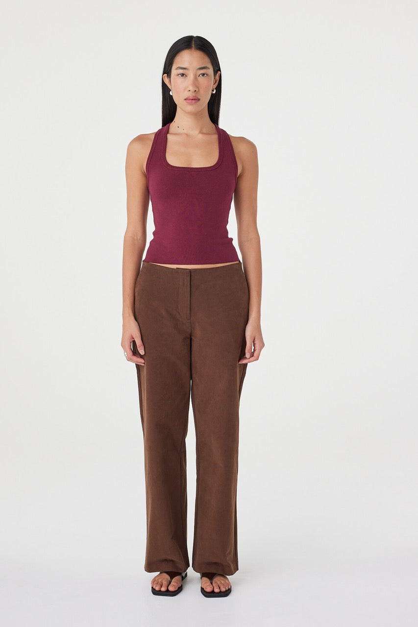 Front view of the Avery Pant in espresso styled with a fitted merlot tank, featuring a straight-leg silhouette, clean waistband and soft drape through the leg