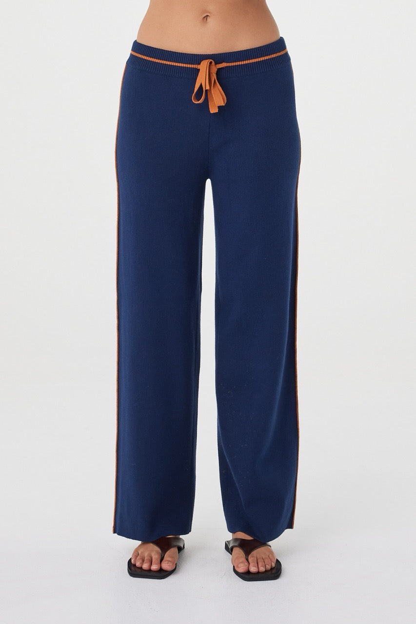 Front view of the Milan Pant in Navy & Tumeric showcasing the elasticated waistband, contrast tumeric drawcord and soft drape through the leg.