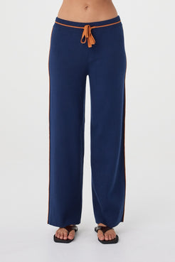 Front view of the Milan Pant in Navy & Tumeric showcasing the elasticated waistband, contrast tumeric drawcord and soft drape through the leg.
