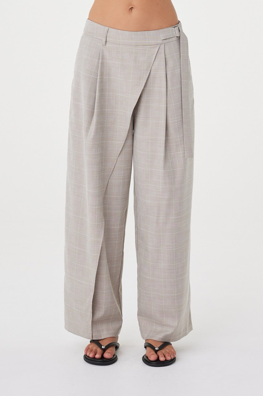 Close-up front view of the  Calla Pant in Taupe Plaid highlighting the wrap construction, buckle detail and tailored waistband.