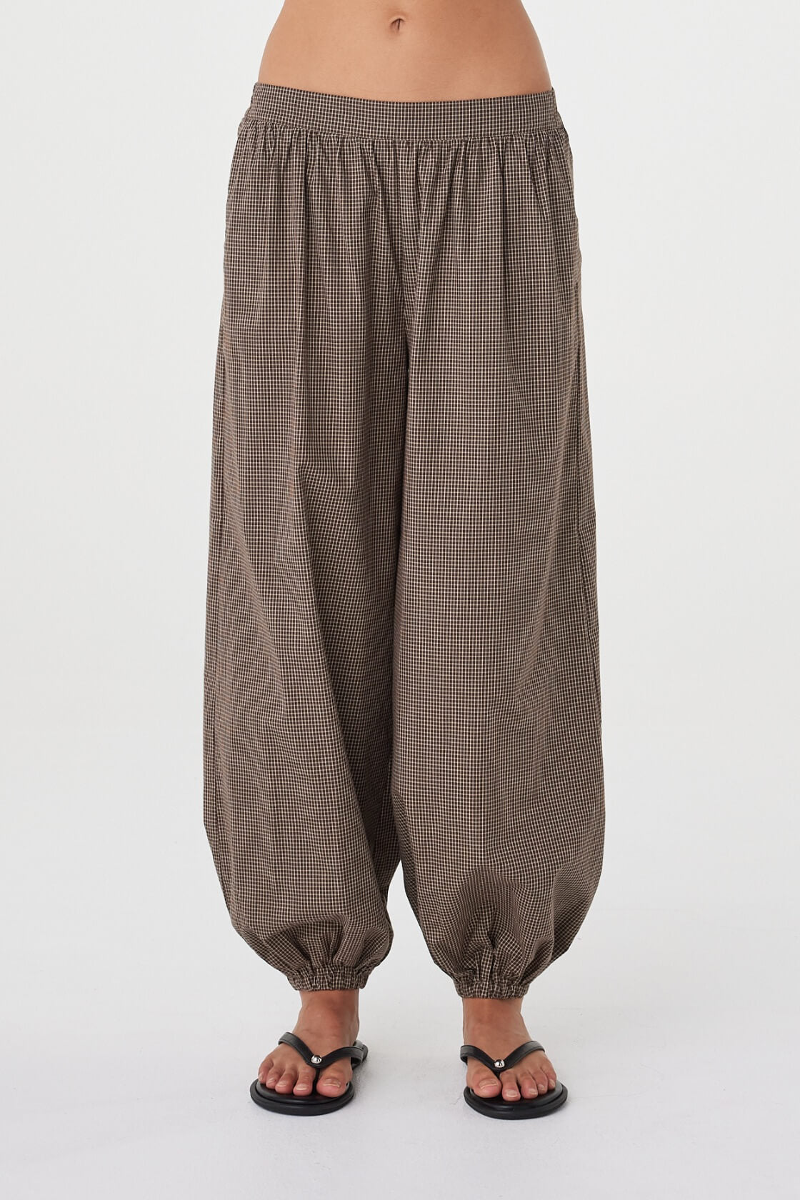 Front view of the Elina Balloon Pant in Chocolate Check showcasing the voluminous leg shape, fixed front waistband and gathered ankle detail.
