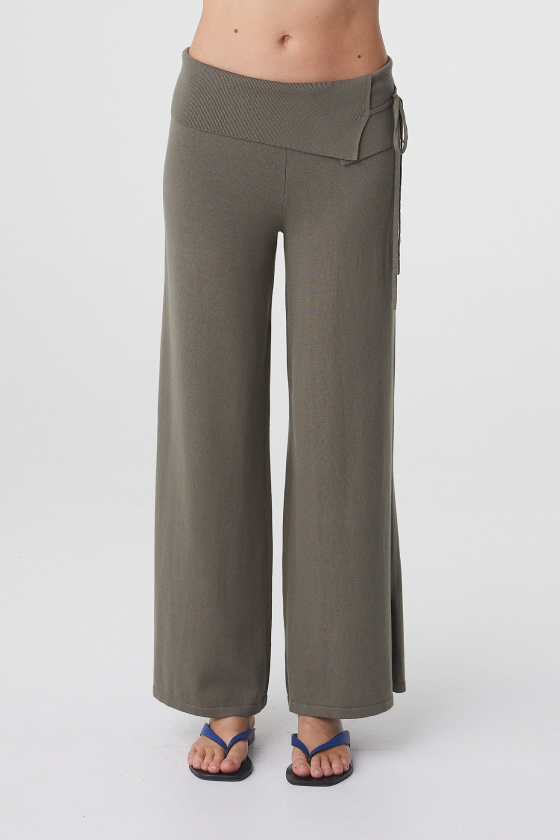 Nora Pant in Smokey Olive, front detail view showing the fold over waistband, adjustable side tie and wide leg shape.