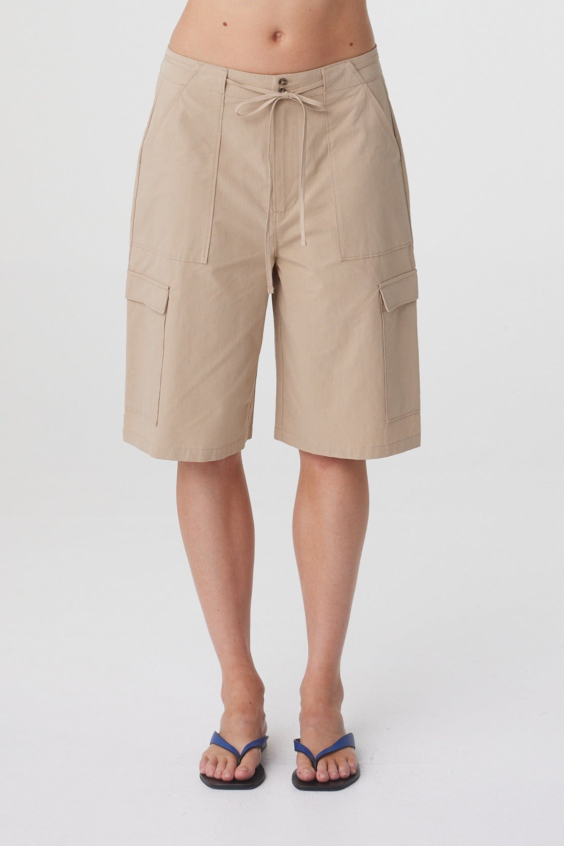 Daria Short in Camel, close front view highlighting the mid rise waist, front tie and cargo style pockets.