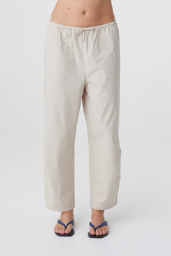 Lena Barrel Pant in Taupe, close front view highlighting the elasticated drawstring waistband, patch pockets and curved leg shape.