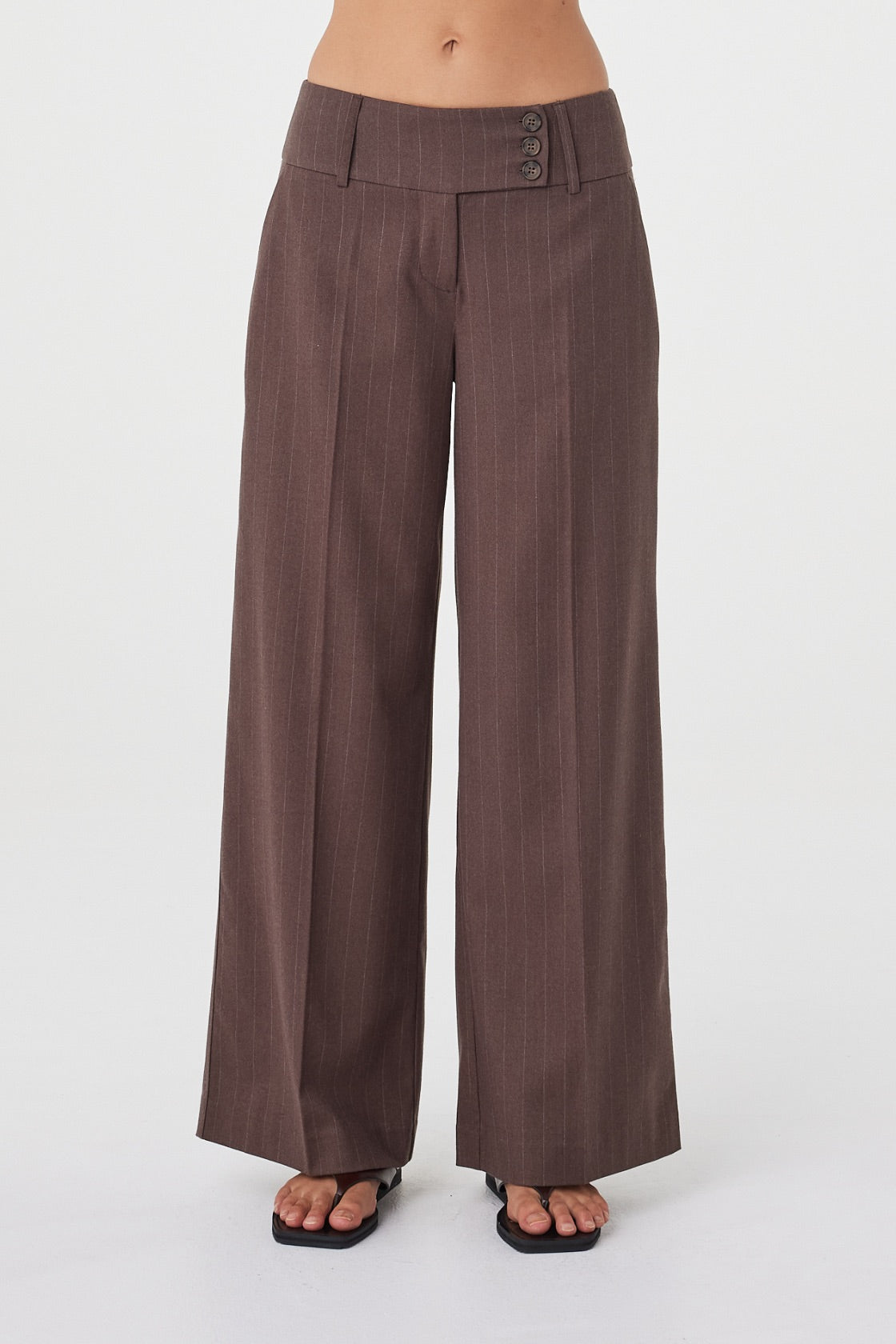 Front detail view of the Manon Pant in Espresso Pinstripe showcasing the wide-leg fit, tailored waistband and subtle pinstripe fabrication.