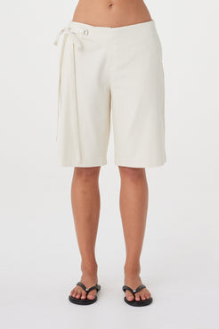 Front view of the Lucia Tie Bermuda Short in Bone highlighting the fabric overlap waistband, silver eyelets and double tie detail.
