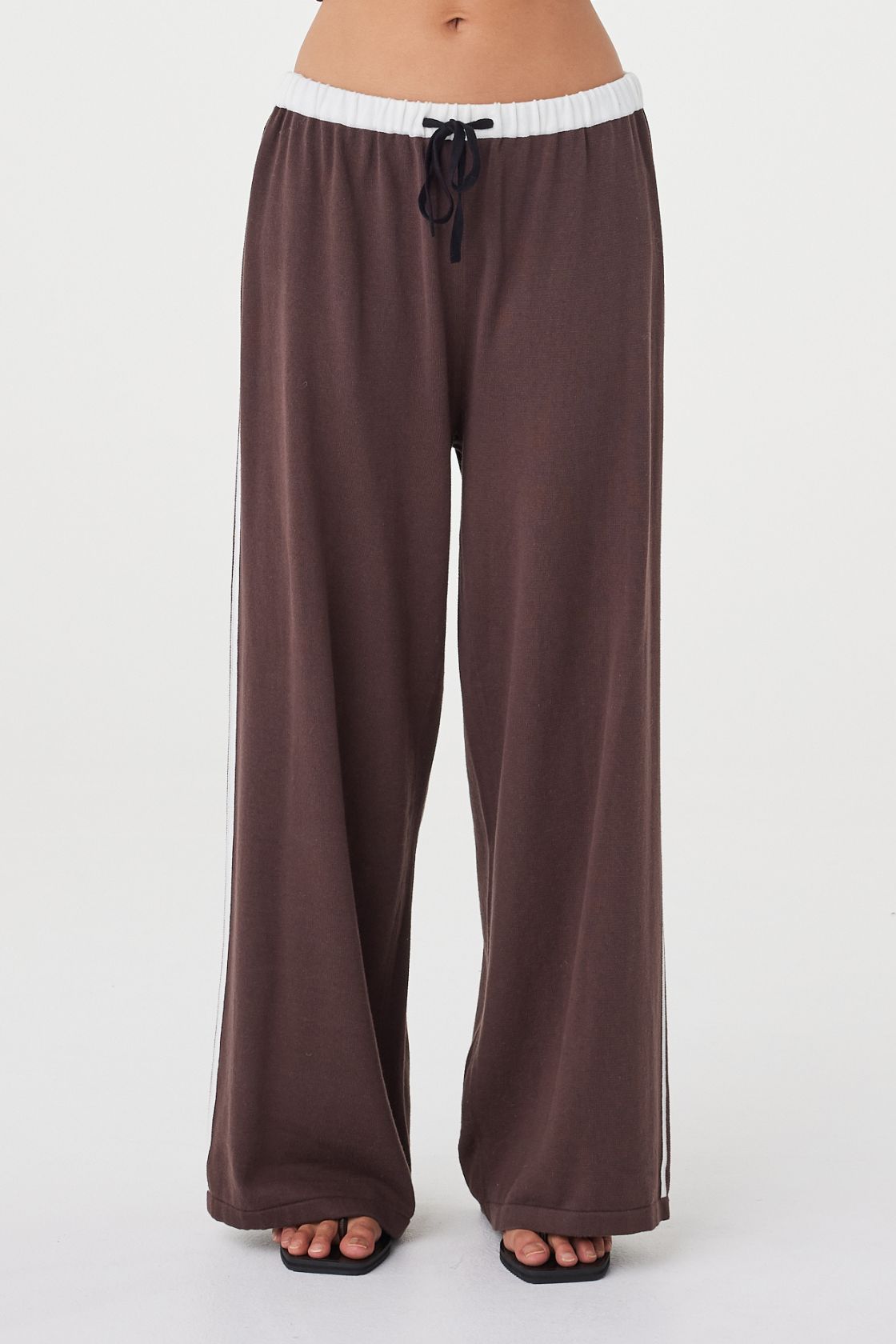 Close-up front view of the Tully Pant in espresso featuring the contrast cream waistband, black drawstring tie and double side stripe detail in cream