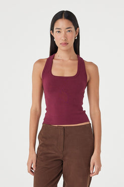 Angled full-length view of the Sable Top in merlot highlighting the soft stretch knit texture, fitted silhouette and rich tonal styling with espresso pants