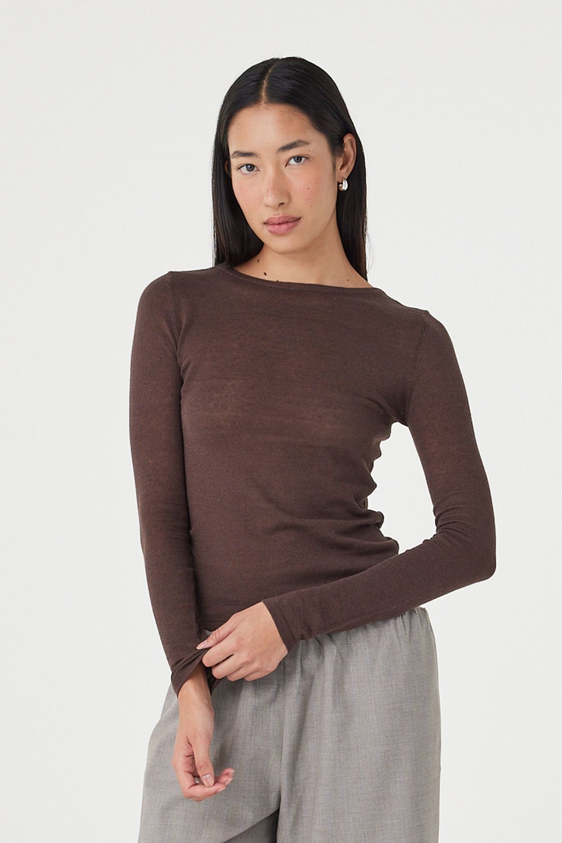 Angled front view of the Aston LS Top in espresso styled with relaxed taupe pants, highlighting the soft drape, sheer texture and minimal everyday styling