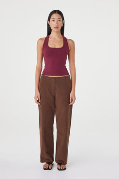 Full-length front view of the Sable Top in merlot styled with espresso straight-leg pants and black sandals, featuring a clean scoop neckline and minimal slim fit