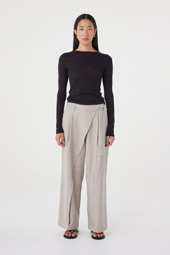 Front view of the Calla Pant in Taupe Plaid featuring a mid-rise fit, wrap-front detail and metal buckle closure, styled with the Aston LS in Black.