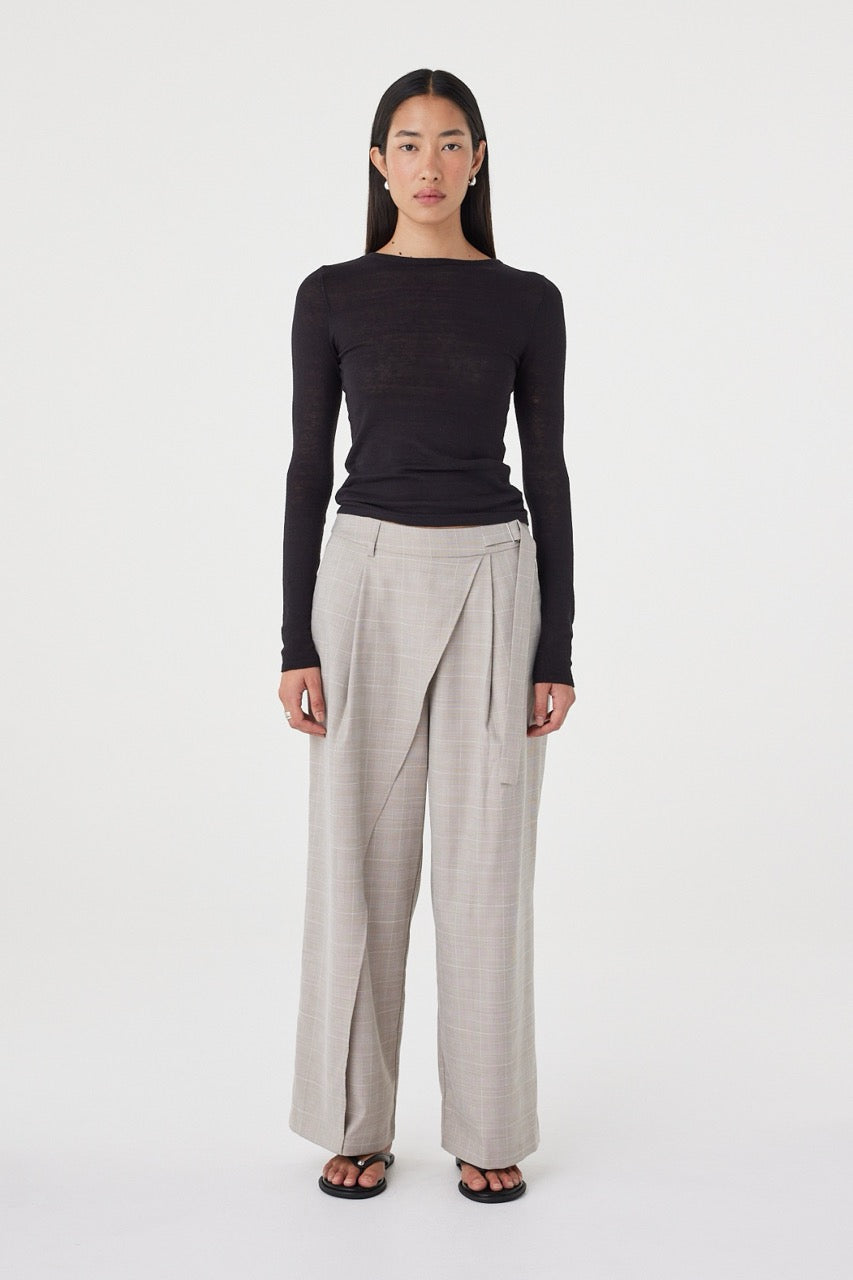 Front view of the Calla Pant in Taupe Plaid featuring a mid-rise fit, wrap-front detail and metal buckle closure, styled with the Aston LS in Black.