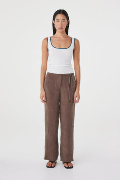 Front full-length view of the Maisie Tie Pant in Espresso featuring a mid-rise waist, side tie detailing and relaxed straight-leg silhouette, styled with a cream tank.
