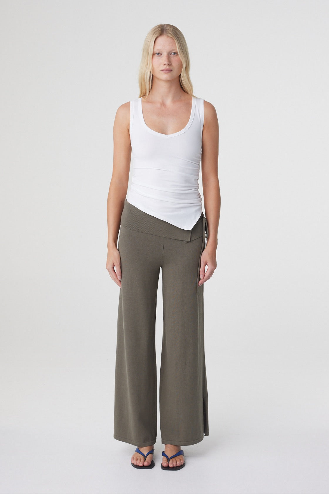 Nora Pant in Smokey Olive, full length front view showing the mid rise asymmetrical waistband and relaxed wide leg silhouette.