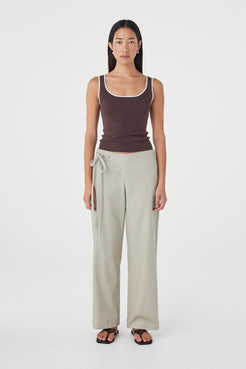 Front view of the Lucia Tie Pant in Light Sage featuring adjustable double waist ties, a relaxed straight-leg silhouette and soft cotton fabrication, styled with an espresso tank.